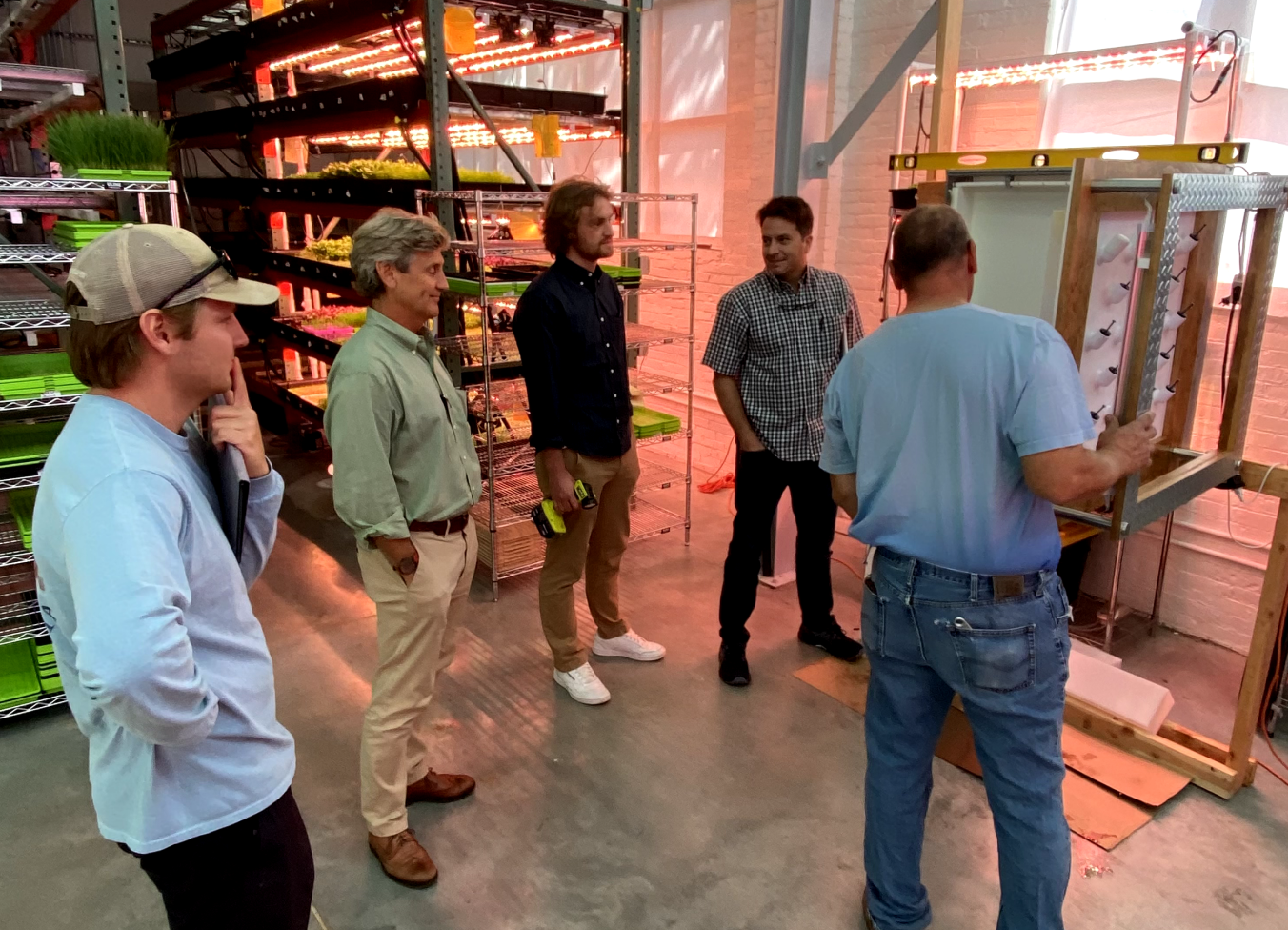 people standing around the Redible products in a warehouse